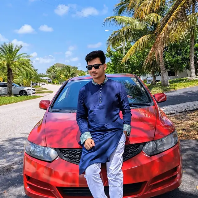 Naim Bin Hasan in a panjabi under the palm trees of South Florida.