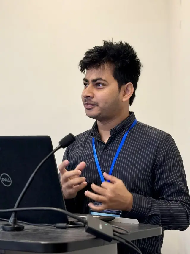 Naim Bin Hasan presenting his research on digital labor and AI at an academic conference.